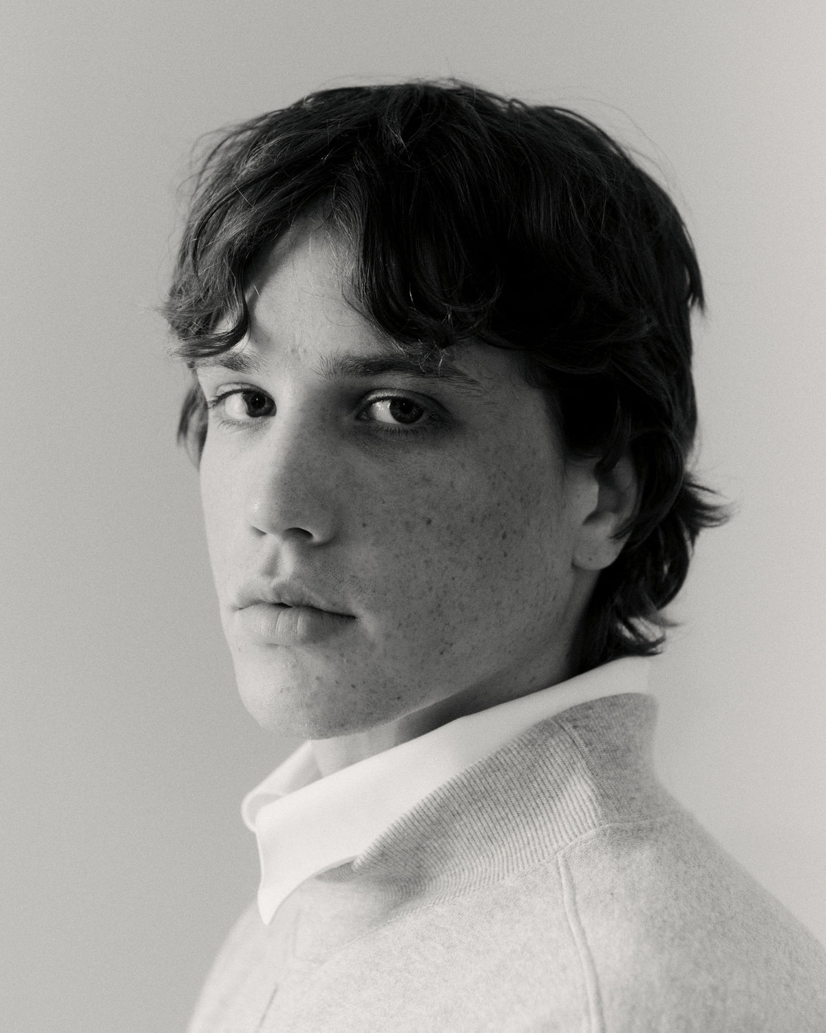 Black and white portrait of a model wearing a white shirt