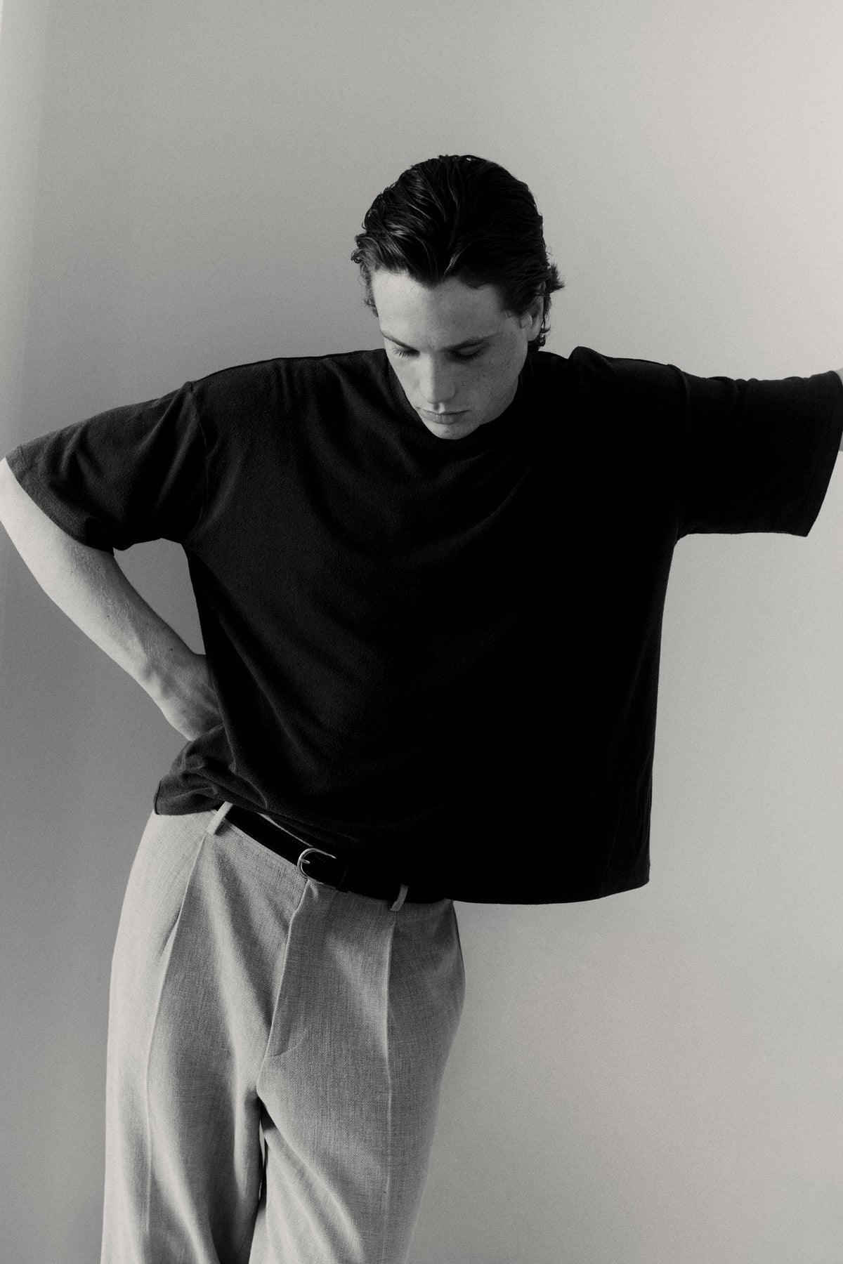 Black and white portrait of a model wearing a dark polo